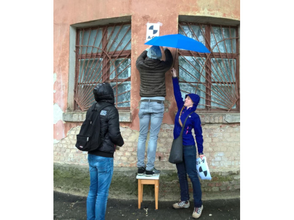 Surveying in Kyiv under an umbrella