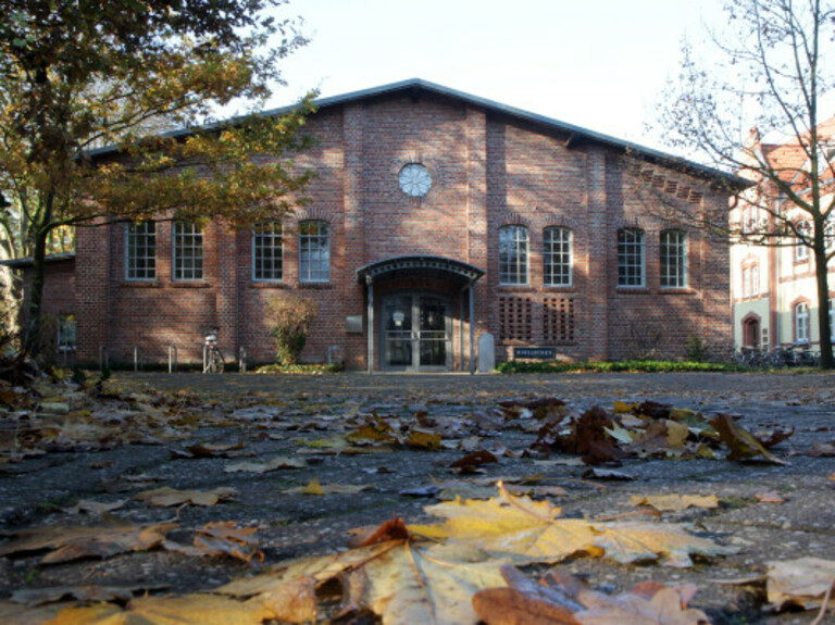 Exterior shot of Oldenburg Library with autumn leaves in the foreground