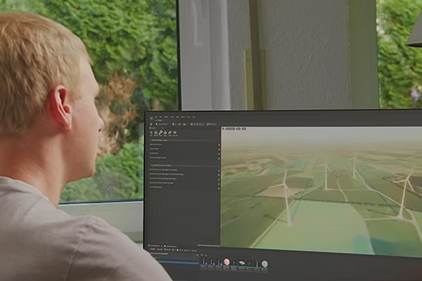 Student schaut auf Bildschirm mit Visualisierung von Windpark